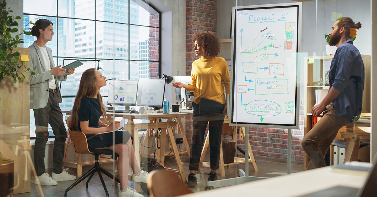 Four people talking in a meeting room