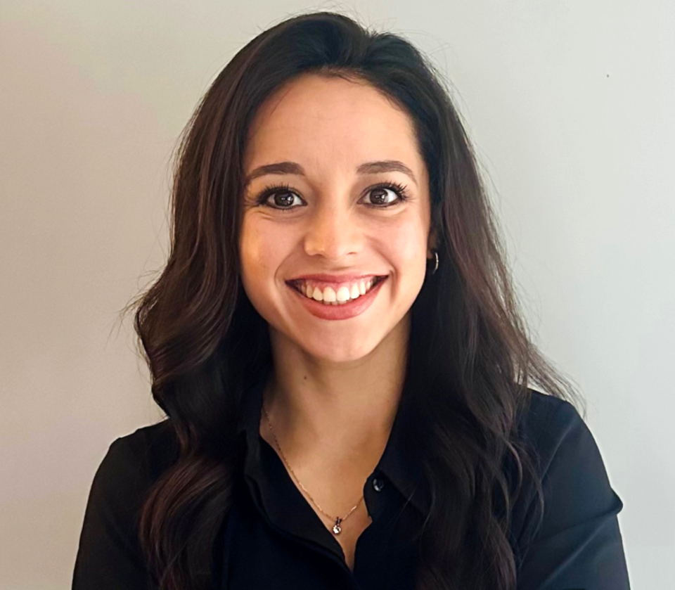 Photo of smiling woman with long hair and a black shirt