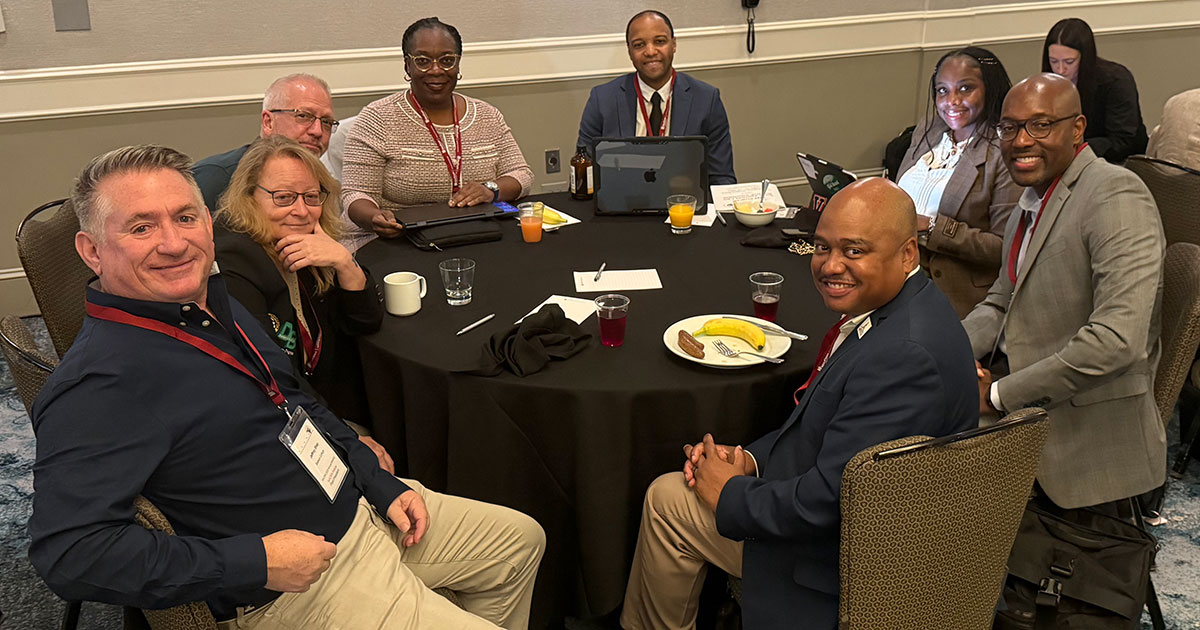 A group of educators sit areound a table
