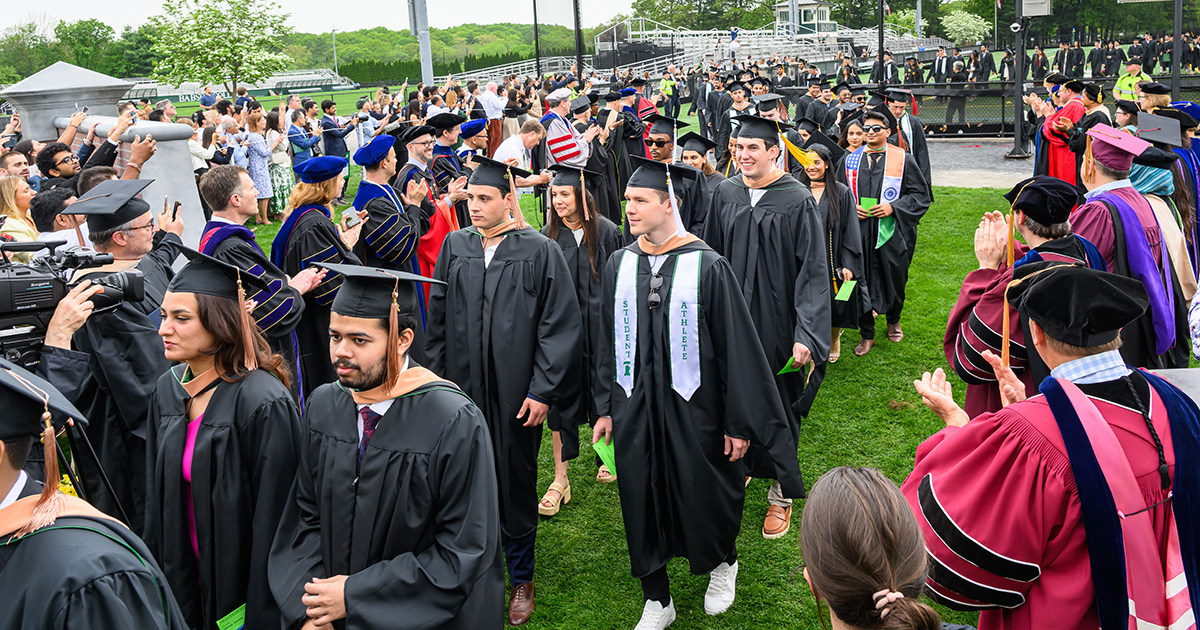 Grad students walk at commencement