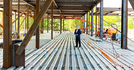 President Spinelli standing in the new elcc construction