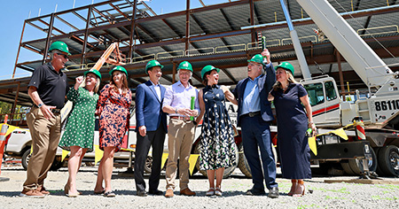 People celebrate outside of a construction site