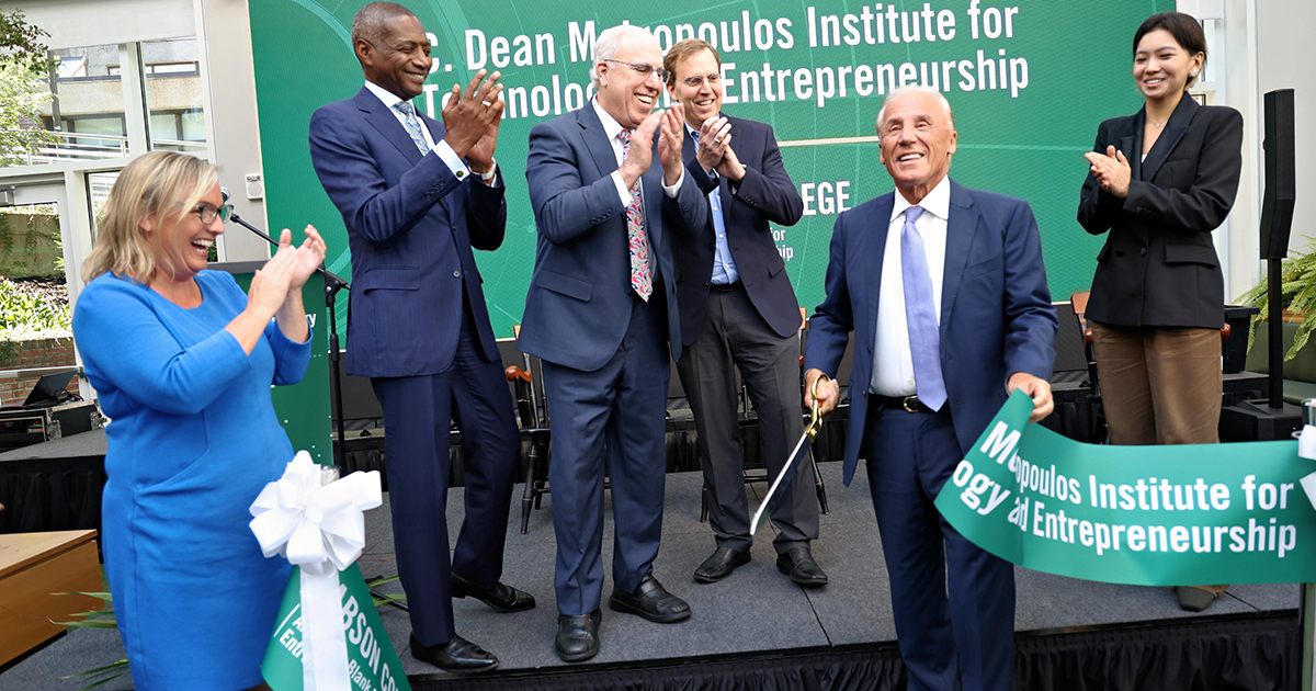 A man cutting a ribbon