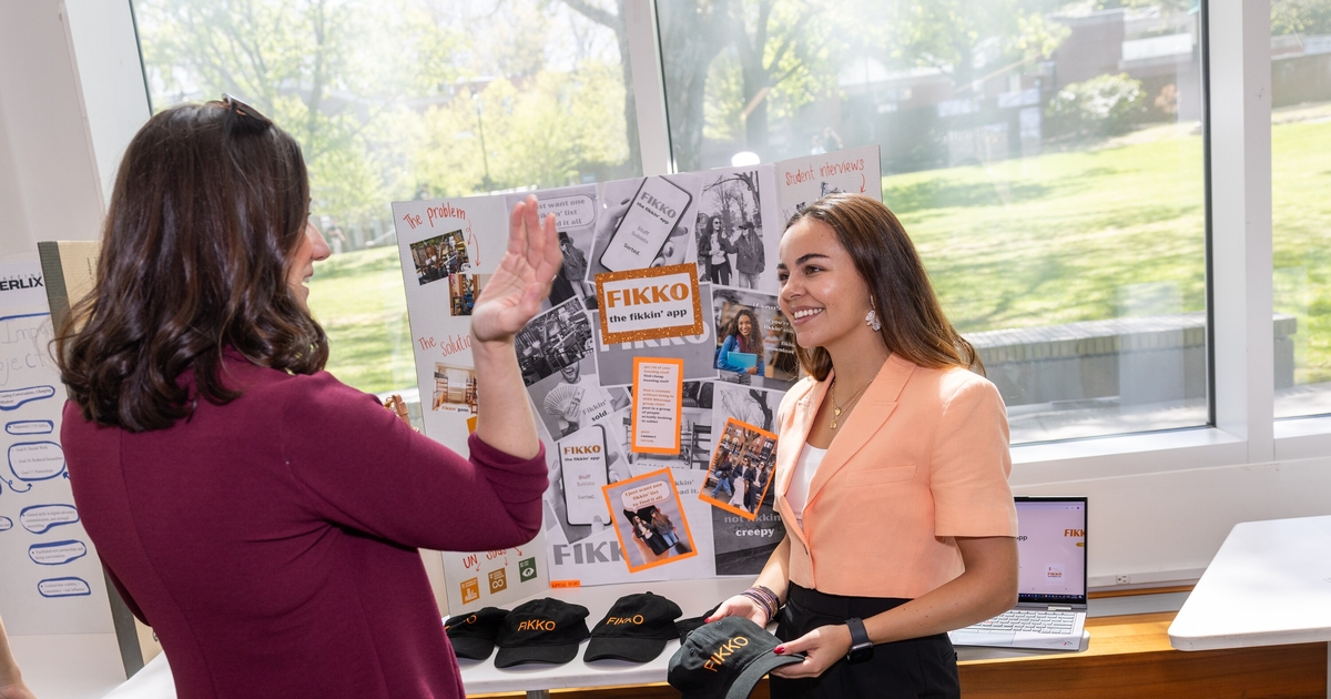 A student presenting an app to a faculty member